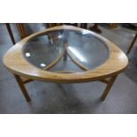 A Nathan teak and glass topped triangular coffee table