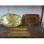 An Art Nouveau brass tray and two inlaid trays