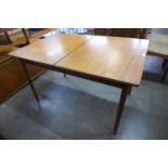 A teak extending dining table