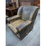An Art Deco brown leather armchair