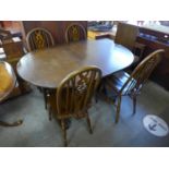 An Old Charm oak extending dining table and four chairs