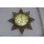 A Junghans Ato-Mat gilt metal sunburst wall clock