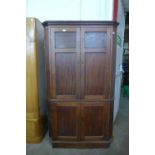 A George III mahogany freestanding splay front corner cupboard