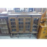 An early 20th Century carved oak four door breakfront bookcase