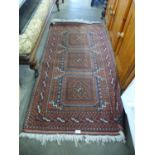 A terracotta ground rug, 153 x 84cms