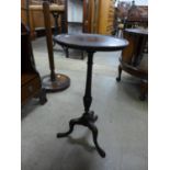 A mahogany tripod wine table