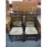 A set of four oak and rush seated ladderback chairs