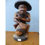 An African carved figure of a man and drum