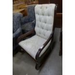 An early Victorian mahogany and upholstered rocking chair