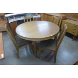 A teak extending dining table and four chairs