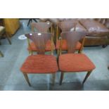 A set of four teak dining chairs