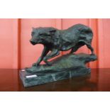 A bronze figure of a bear, on marble plinth