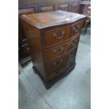 A small mahogany serpentine chest of drawers