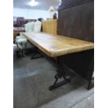 A pine and cast iron based pub/refectory table