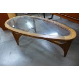 A Stonehill Stateroom teak and glass topped oval coffee table