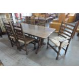 A Nigel Griffiths carved oak refectory table and six chairs