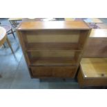 A teak bookcase, coffee table, telephone seat and a box