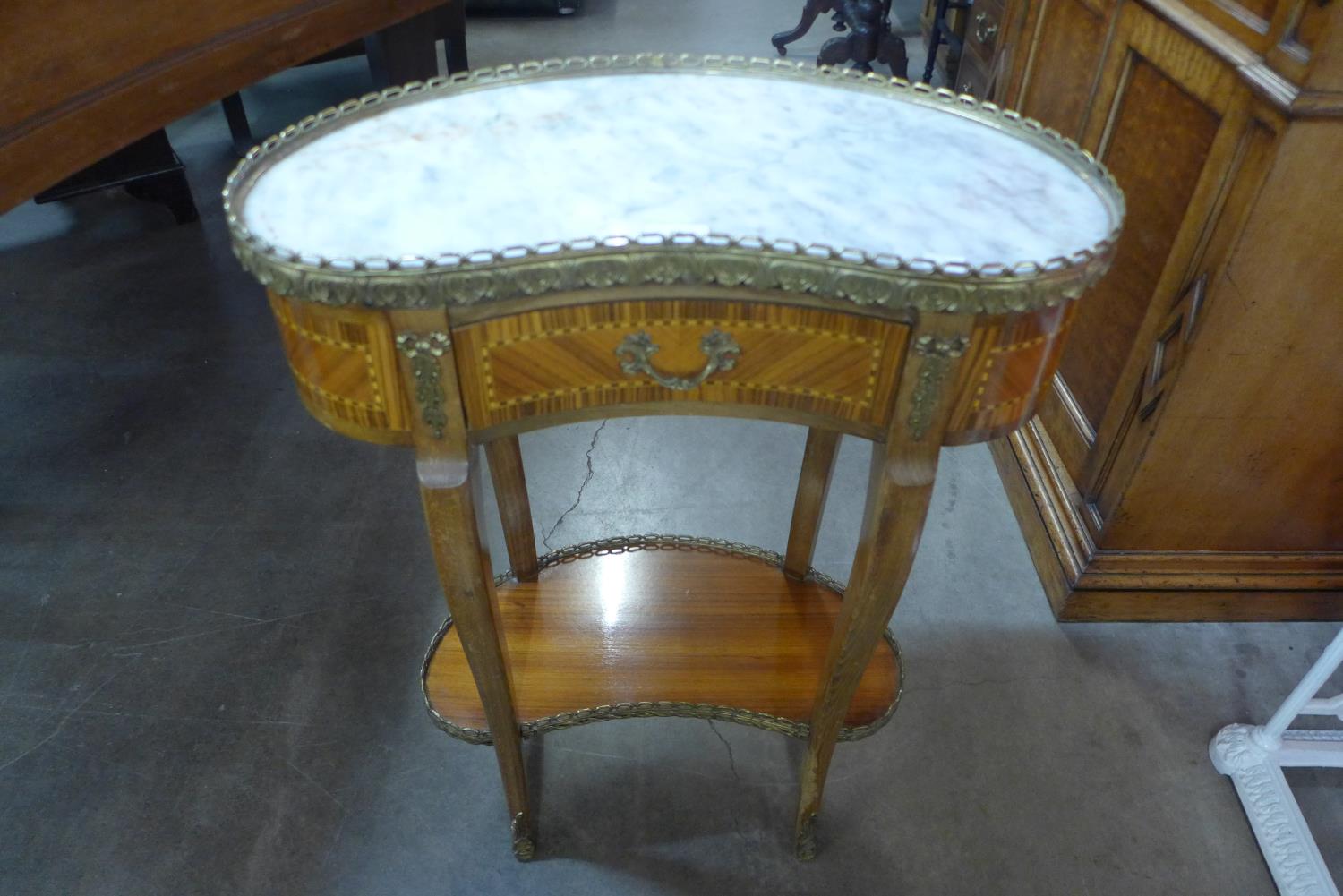 A French Louis XV style inlaid mahogany, gilt metal and marble topped kidney shaped occasional table