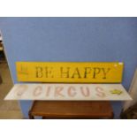 Two painted signs; Circus and Be Happy