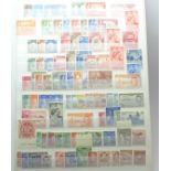 Stamps:- KGVI Commonwealth mint stamps in stock book with sets and part sets, noted GB £1 silver