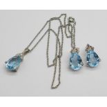 A blue and white stone pendant and earring set