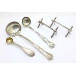 A pair of silver knife rests, two silver ladles and one other silver spoon, 245g
