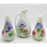 A hand painted condiment set; salt, pepper and oil/vinegar, possibly E Radford