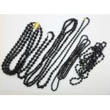 Six black glass bead necklaces