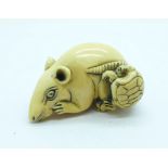 A carved ivory netsuke of a rat with tortoise