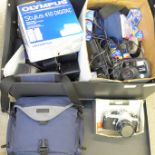 A box of camera equipment including two lenses, Pentax ME Super, Olympus digital, Canon EOS 33 and