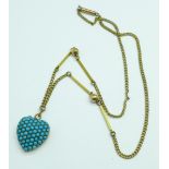 A turquoise set heart shaped pendant on a plated chain