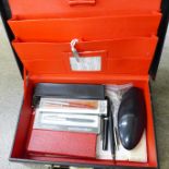 A fitted leather writing case, an Aston & Mander ivory ruler, pens, etc.