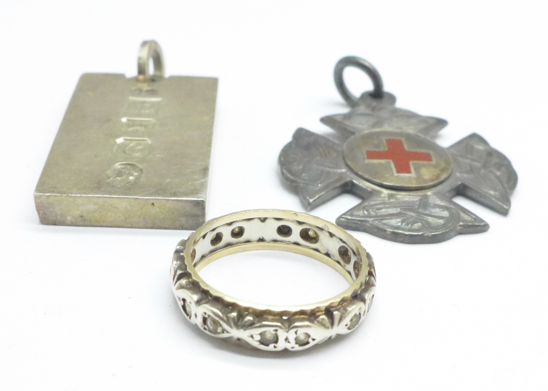 A silver ingot, silver fob and an eternity ring (tests as silver and gold), 47.4g