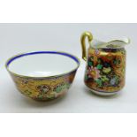 An early 20th Century Noritake hand decorated bowl and milk jug, signed underside, height 10.7cm,