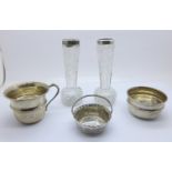 A silver cup, two silver bowls and two silver rimmed glass vases, weight of silver, 118g