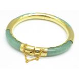 A gilt metal and jade bangle