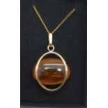 An amber and yellow metal pendant on chain, marked 583, 6.6g