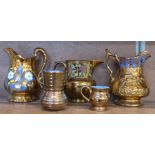 Four copper lustre jugs and a lustre vase