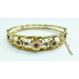 A 9ct gold, ruby and diamond bangle, 8.8g