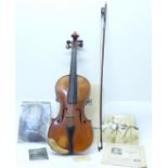 A violin and bow, cased, once the property of Doris Delmer, with photographs and other ephemera,