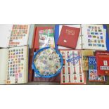 A box of loose stamps, a collection of stamp books, three albums of stamps including English and