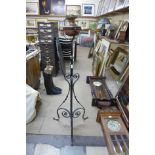 An Art Nouveau wrought iron and copper floor standing oil lamp