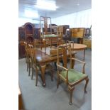 An Edward VII oak extending dining table and eight chairs