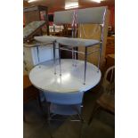 A chrome and Formica topped extending kitchen table and three chairs