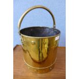 An Arts and Crafts brass coal bucket