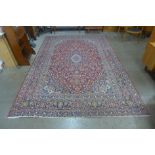 A large red ground rug, 368 x 247cms