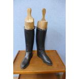 A pair of riding boots, size 11, and wooden boot trees