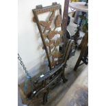 A pair of cast iron bench ends and back panel