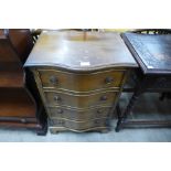 A small yew wood serpentine chest of drawers