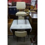 A Formica drop leaf kitchen table and three chairs